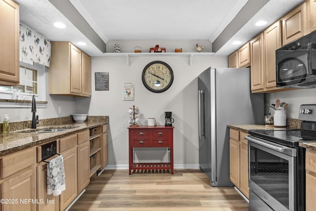 kitchen featuring appliances with stainless steel finishes, dark stone countertops, ornamental molding, and sink