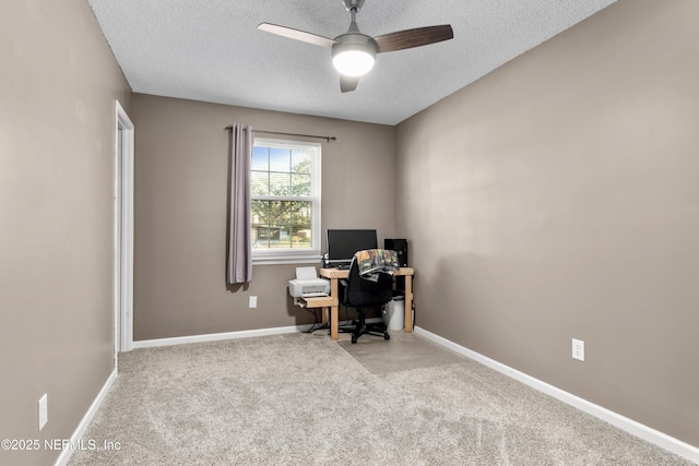 carpeted home office with ceiling fan and a textured ceiling