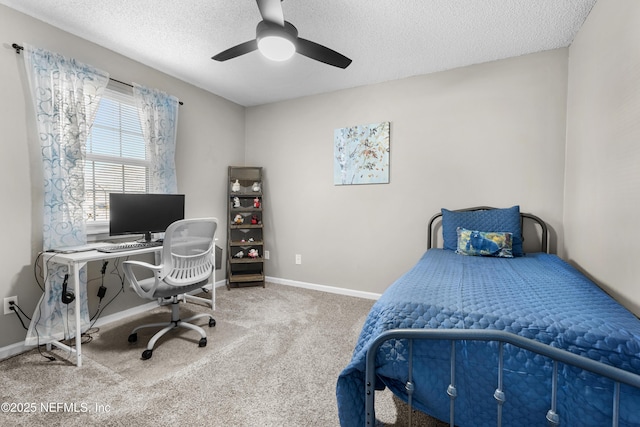 bedroom with ceiling fan, carpet, and a textured ceiling