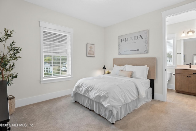 carpeted bedroom featuring ensuite bath