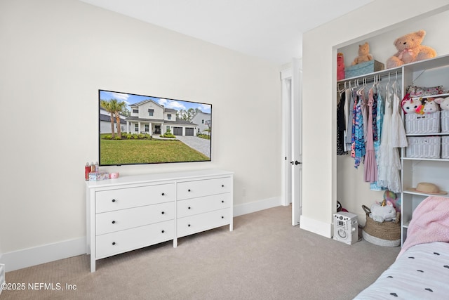 bedroom with a closet and light carpet