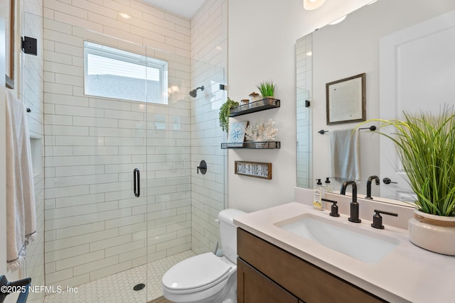 bathroom featuring toilet, vanity, and an enclosed shower