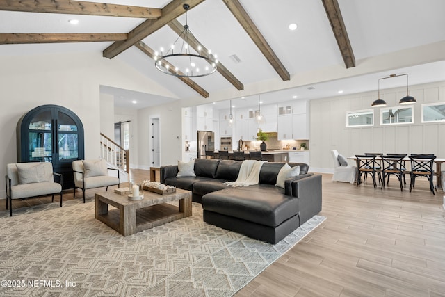 living room with high vaulted ceiling, sink, beam ceiling, and a notable chandelier