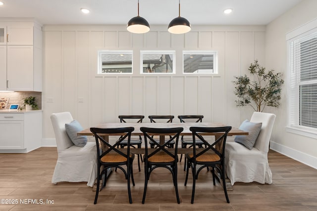 dining space featuring wood-type flooring