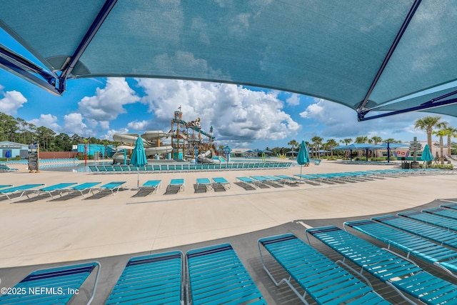 view of swimming pool featuring a playground