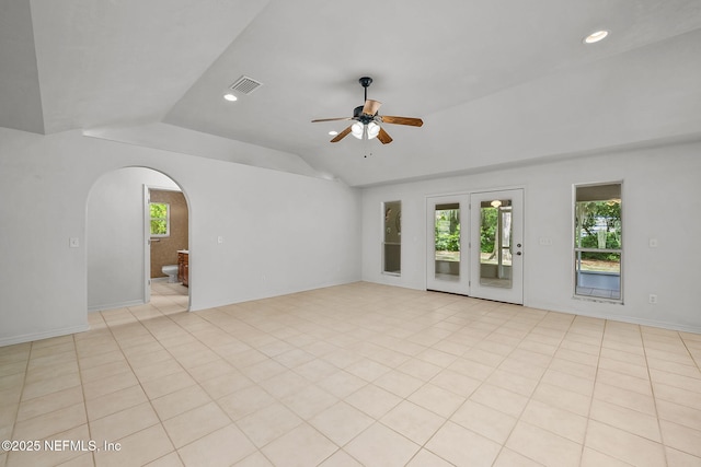 spare room featuring a wealth of natural light, ceiling fan, light tile patterned floors, and lofted ceiling