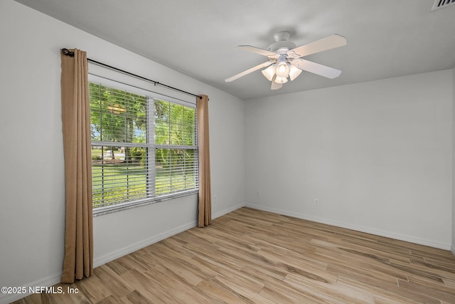 spare room with ceiling fan and light hardwood / wood-style floors