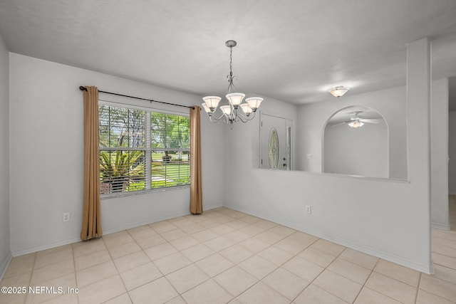 tiled spare room featuring ceiling fan with notable chandelier