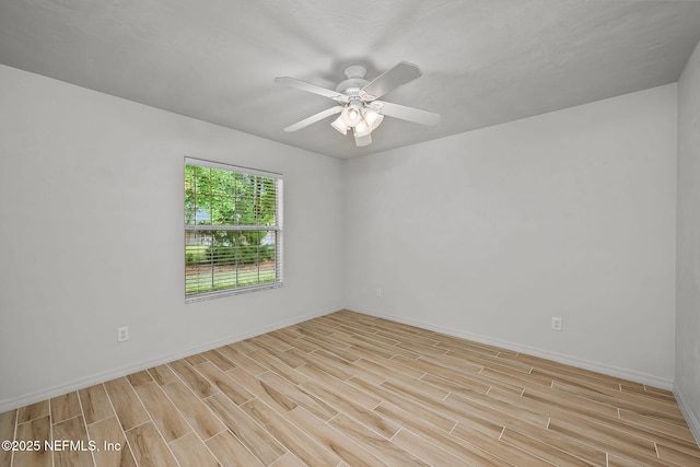 spare room with light hardwood / wood-style floors and ceiling fan