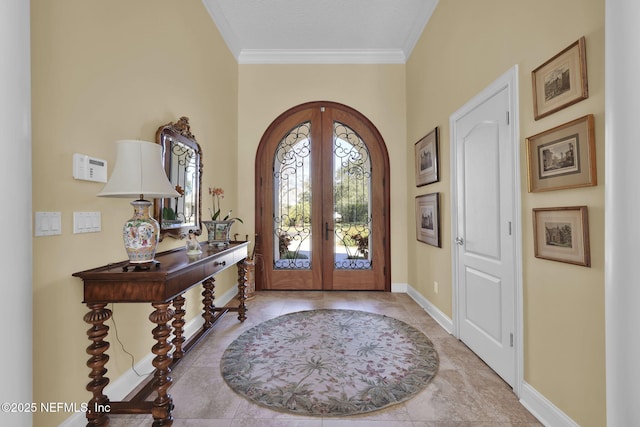 foyer featuring crown molding and french doors