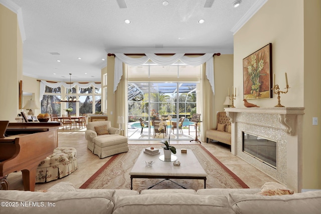 living room with a textured ceiling, crown molding, and a fireplace