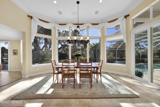 sunroom with plenty of natural light and a notable chandelier