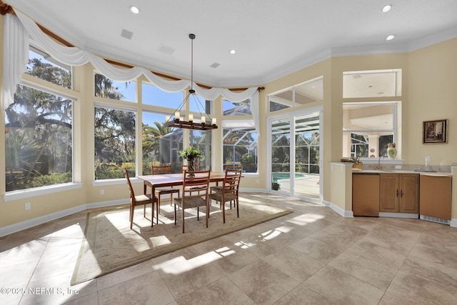 sunroom / solarium featuring sink and an inviting chandelier