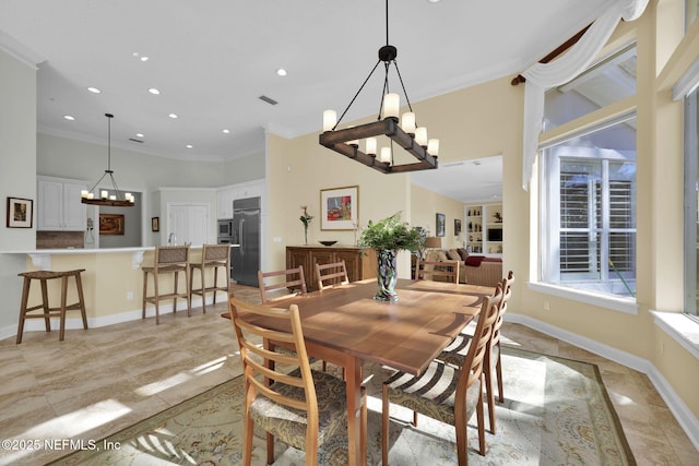 dining room featuring light tile patterned floors and ornamental molding