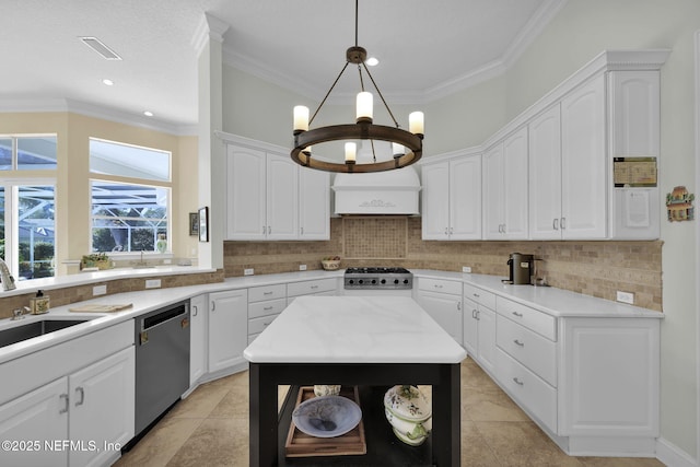 kitchen with a kitchen island, stainless steel dishwasher, white cabinets, and hanging light fixtures