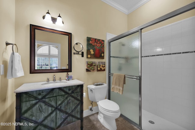 bathroom with toilet, vanity, a shower with door, and crown molding