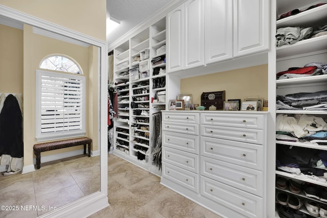 walk in closet featuring light tile patterned flooring