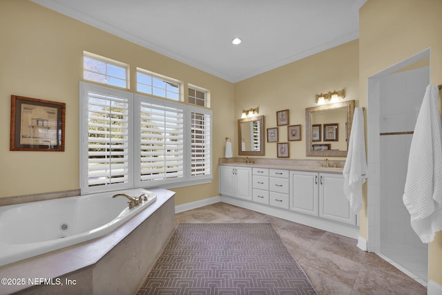 bathroom with crown molding, tiled tub, and vanity