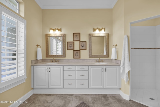 bathroom featuring a healthy amount of sunlight, vanity, and ornamental molding