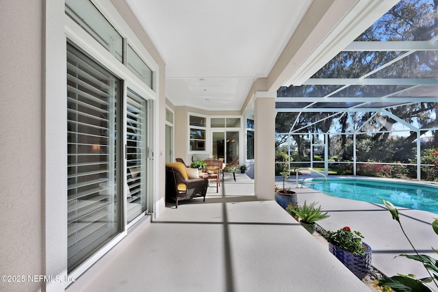 view of swimming pool featuring a patio area and glass enclosure