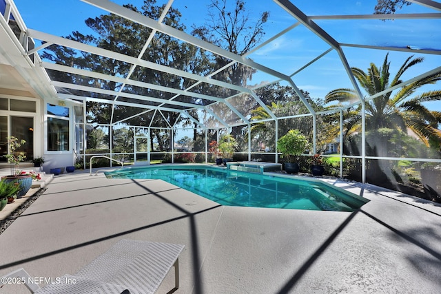 view of swimming pool featuring a lanai and a patio