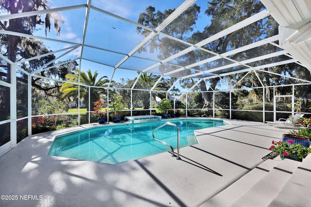 view of pool with a lanai and a patio area