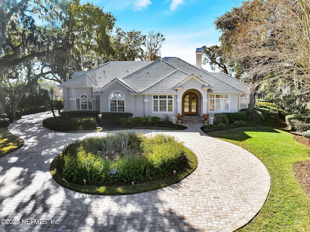 view of front of property with a front yard and french doors