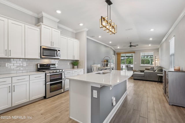 234 Thistleton Way, Saint Augustine, FL 32092 - kitchen featuring stainless steel appliances, a ceiling fan, recessed lighting, light wood-style flooring, and open floor plan