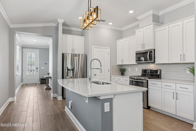 234 Thistleton Way, Saint Augustine, FL 32092 - kitchen featuring appliances with stainless steel finishes, wood finished floors, tasteful backsplash, a center island with sink, and recessed lighting