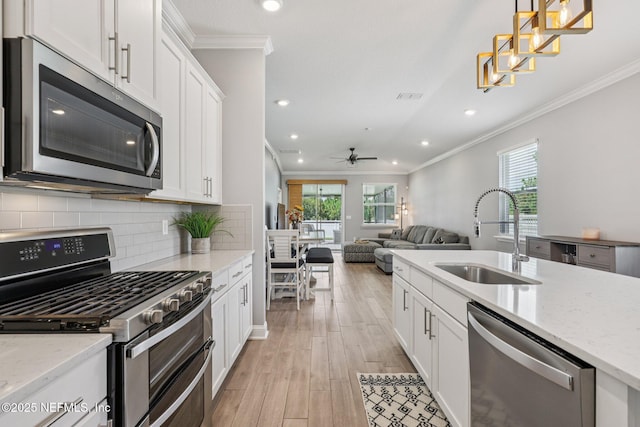 234 Thistleton Way, Saint Augustine, FL 32092 - kitchen featuring stainless steel appliances, crown molding, white cabinets, recessed lighting, and ceiling fan