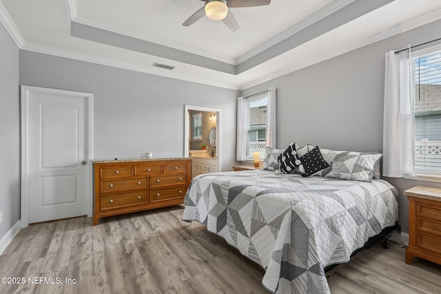234 Thistleton Way, Saint Augustine, FL 32092 - bedroom with multiple windows, wood finished floors, a tray ceiling, ornamental molding, and ceiling fan