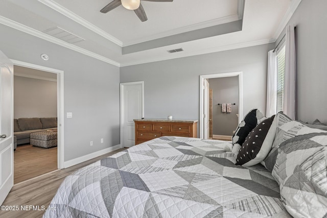 234 Thistleton Way, Saint Augustine, FL 32092 - bedroom with light wood-style flooring, a tray ceiling, ornamental molding, and a ceiling fan