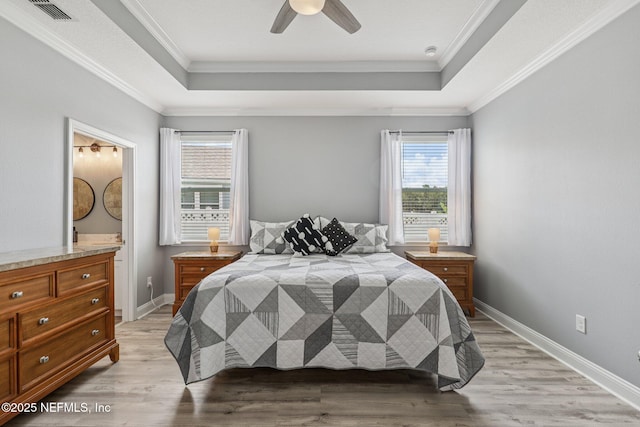 234 Thistleton Way, Saint Augustine, FL 32092 - bedroom with a raised ceiling, light wood finished floors, crown molding, ensuite bath, and ceiling fan