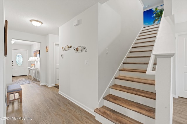 stairs with hardwood / wood-style flooring