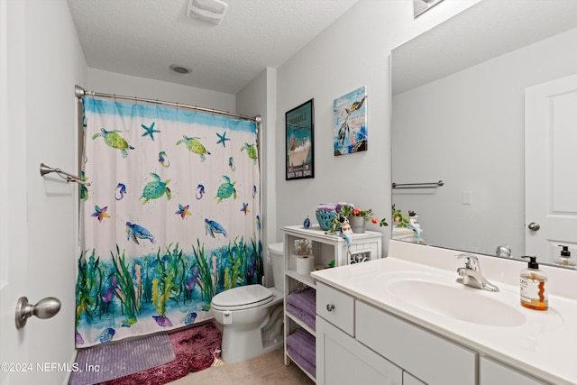 bathroom with curtained shower, tile patterned floors, a textured ceiling, toilet, and vanity