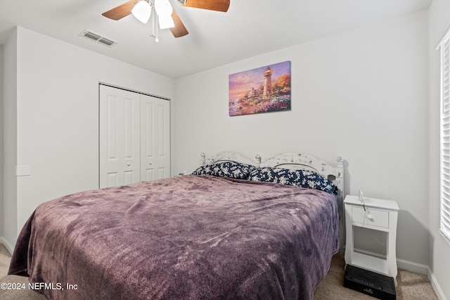 carpeted bedroom featuring ceiling fan and a closet