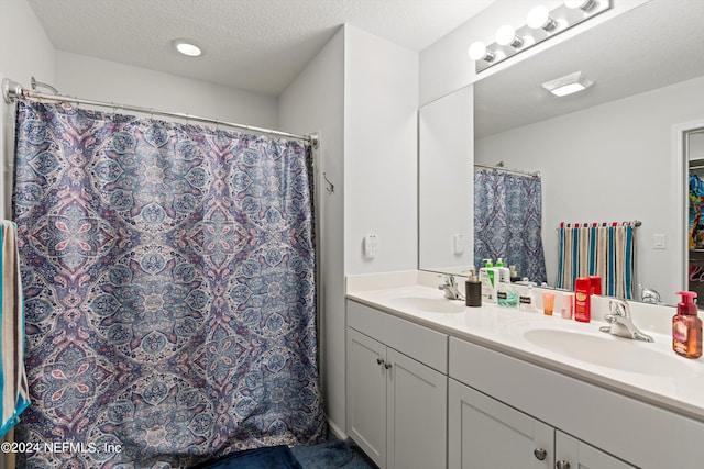 bathroom with vanity and a textured ceiling