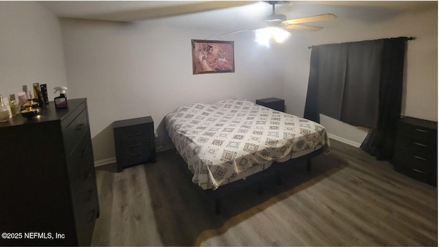 bedroom featuring ceiling fan and dark hardwood / wood-style flooring