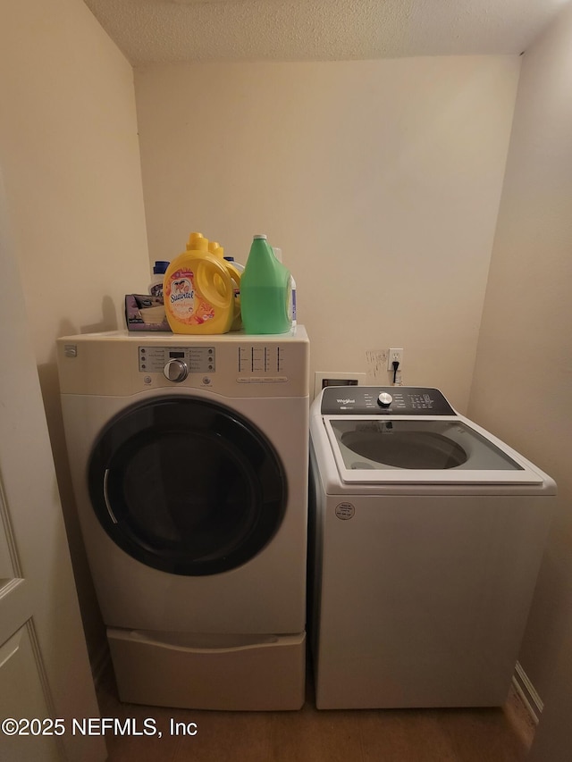 washroom featuring separate washer and dryer and a textured ceiling