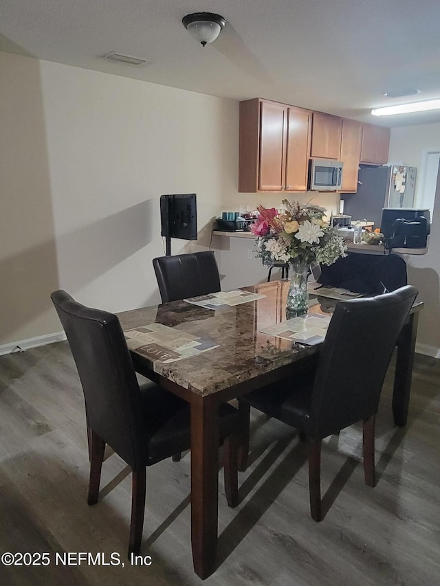 dining room featuring wood-type flooring