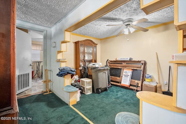 office space with ceiling fan, ornamental molding, a textured ceiling, and dark colored carpet