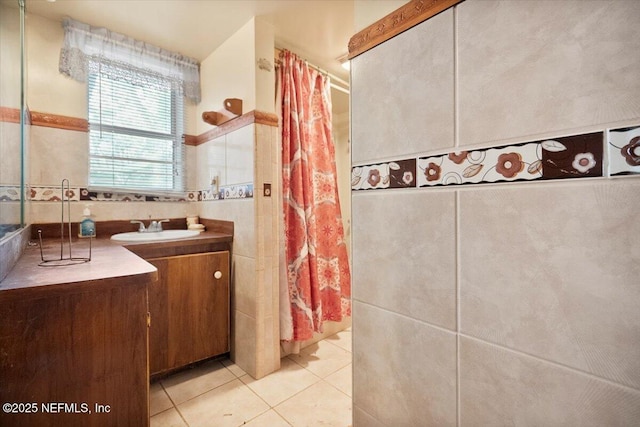 bathroom with tile walls, vanity, and tile patterned floors