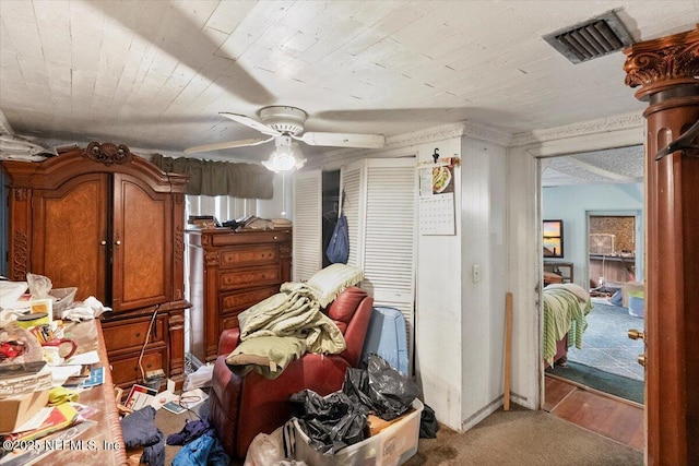 interior space with ceiling fan