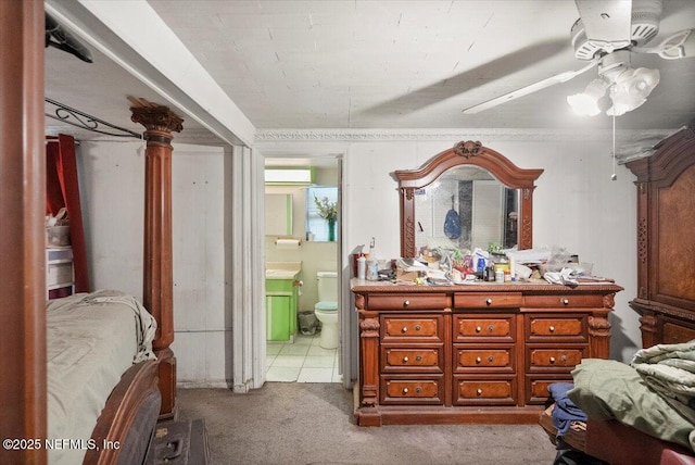 carpeted bedroom featuring ceiling fan and ensuite bath