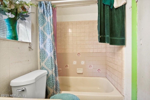 bathroom featuring shower / bath combination with curtain and toilet