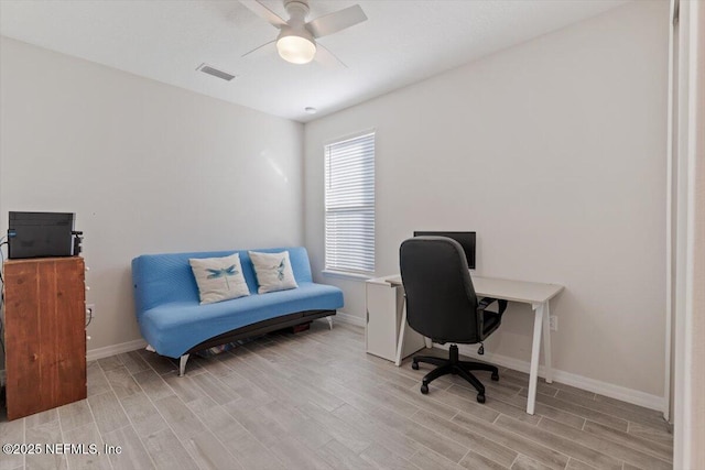 home office with ceiling fan and light hardwood / wood-style flooring