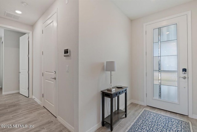 foyer entrance with light hardwood / wood-style flooring