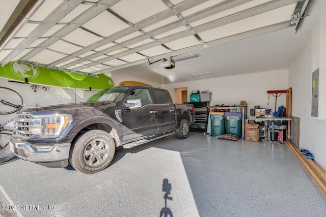 garage with electric panel, a carport, and a garage door opener