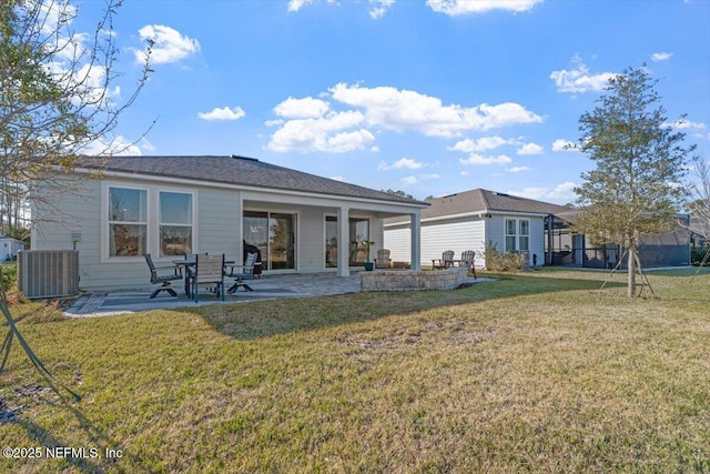 rear view of house featuring a lawn, central AC, and a patio