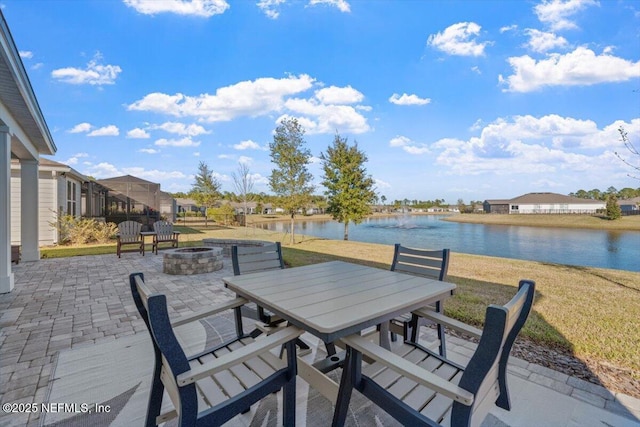 view of patio / terrace with a fire pit and a water view